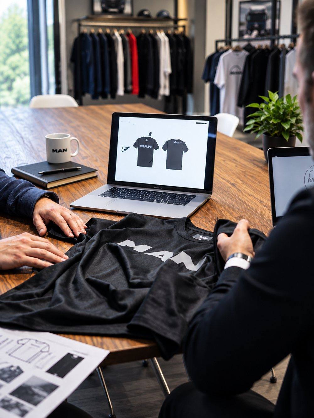 Team reviewing fabric samples and fit patterns for a client